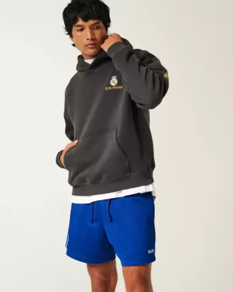 Fotbollsshorts med stickad logotyp på mitten av låret