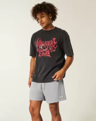 Fotbollsshorts med stickad logotyp på mitten av låret