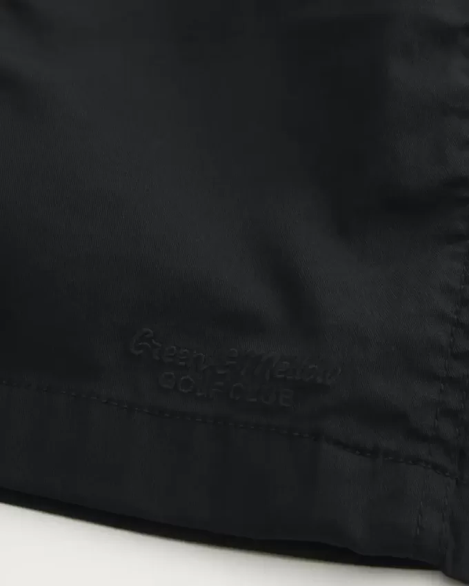 Golfshorts som kyler över knäet