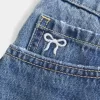 Kurvlig låg-Rise broderad rosett Denim Mini Skort Kurvlig låg-Rise broderad rosett Denim Mini Skort
