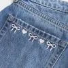 Kurvlig låg-Rise broderad rosett Denim Mini Skort Kurvlig låg-Rise broderad rosett Denim Mini Skort