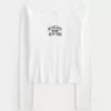 Montauk grafisk t-shirt med spetskanter utanför axeln Montauk grafisk t-shirt med spetskanter utanför axeln